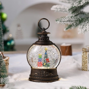 Detail of a vintage bronze Christmas lantern with a festive tree and glitter snow effect