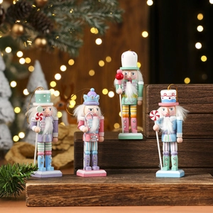 Set of four pastel macaron Nutcracker wood figures on stairs with warm bokeh backdrop
