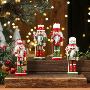Four wooden nutcracker soldiers with glitter details on a wooden stairs background