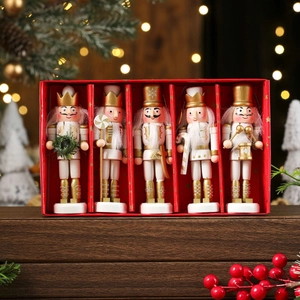 Close-up of five white and gold wooden nutcracker ornaments in a red gift box