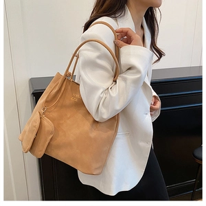 Close-up of soft matte leather tote bag in tan with a small matching coin purse
