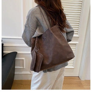 Detailed back view of a large brown faux suede tote bag with a matching small zipper pouch