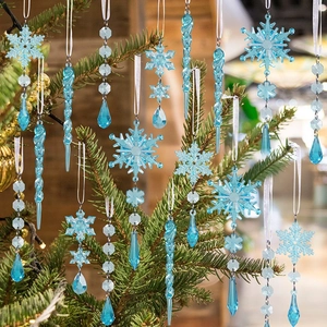 Close-up of light blue acrylic snowflake and icicle ornaments hanging on a Christmas tree