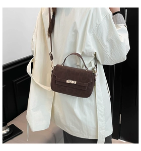 Fashionable leopard print handbag with golden twist lock shown in a stylish side-wear view