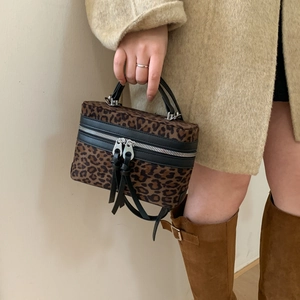 Retro leopard print mini bucket bag with black leather trim and dual silver zippers