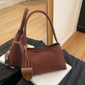 Deep wine red corduroy hobo bag with sleek shoulder strap and leather key pouch pendant