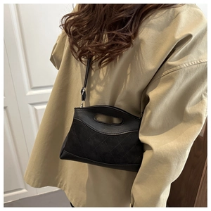 Quilted black crossbody bag styled on a model showing practical size and elegant texture