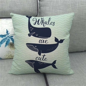 Close-up of blue whale print on mint green linen cushion cover with Whales are cute text