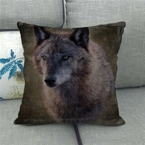 Detailed view of square linen pillowcase with realistic wolf head print on a sofa