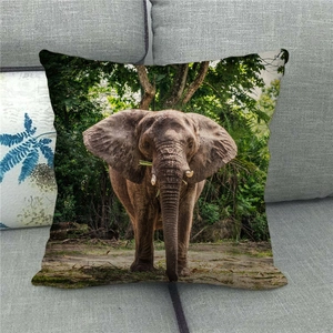 Detail showing the fine linen texture and vibrant elephant print on the cushion cover