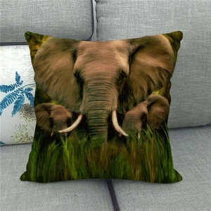 Close-up of elephant family print on linen pillowcase placed on a gray sofa