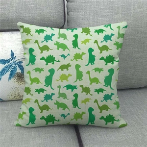 Detailed texture of beige linen pillowcase with green dinosaur silhouette patterns on sofa