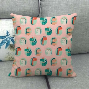 Detailed texture of pink linen cushion cover featuring colorful cartoon dinosaur prints