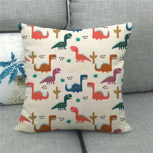 Cartoon dinosaur print linen cushion cover displayed on a gray sofa for home decor