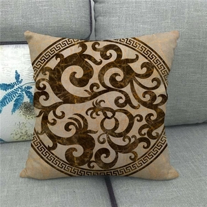 Detail of bohemian linen pillowcase with earthy scroll patterns and Greek key border