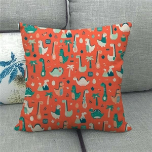 Close-up of linen fabric texture on orange cushion cover with cartoon dinosaur prints