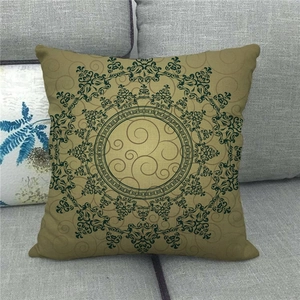Bohemian linen pillowcase with bronze mandala pattern on a modern grey sofa