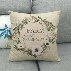 Detailed texture of linen pillowcase with floral wreath and Farm Sweet Farmhouse print