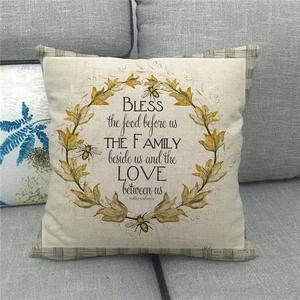 Close-up of linen pillow cover with floral wreath design and farmhouse bee print