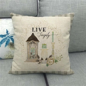 Detail of linen pillowcase with LIVE Simply print and rustic floral wreath decoration