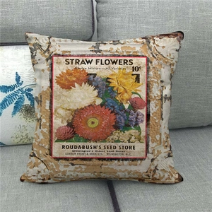 Macro view of vintage linen pillow case with retro flower seed packet print