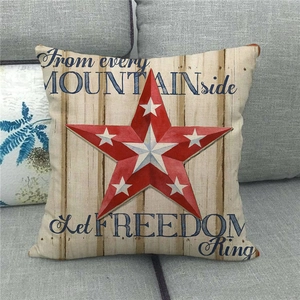 Detail of linen pillow cover featuring red star and patriotic quote on cream background