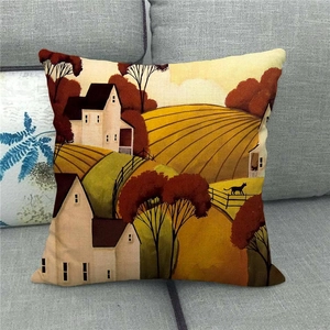 Detail of linen pillowcase with countryside landscape art on a grey sofa