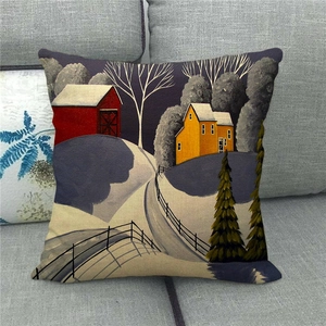 Close-up of winter village oil painting print on linen cushion cover on a sofa