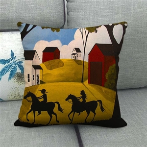 Detail of linen pillowcase featuring a country town oil painting on a gray sofa