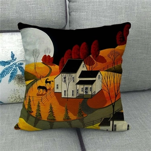 Detail of linen pillow cover with rural village oil painting print on grey sofa