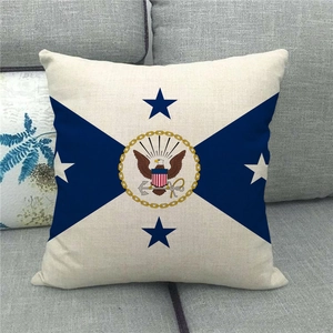 Close-up of linen pillowcase with navy cross pattern and golden eagle nautical emblem