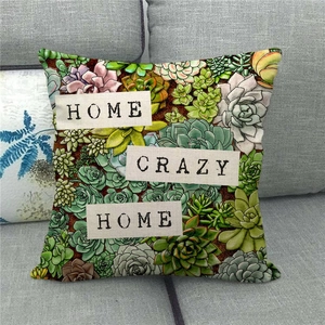 Detail of linen cushion cover with succulents and Home Crazy Home text on sofa