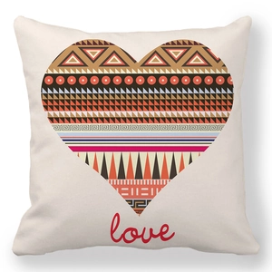 Detail of soft peach skin cushion cover with geometric heart print and love typography
