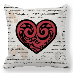 Macro shot of peach skin fabric cushion cover featuring a vintage red heart and scroll pattern