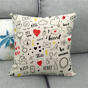 Detailed close-up of linen pillowcase with Valentine's graffiti print on grey sofa