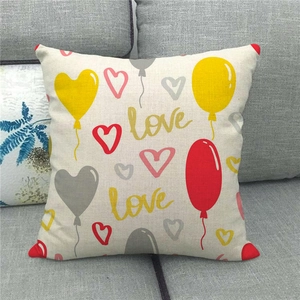 Close-up of linen fabric texture on heart balloon decorative pillow on a grey sofa