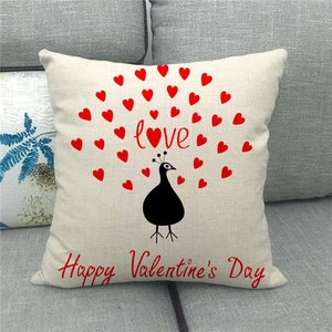 Linen Valentine's Day pillow cover with heart peacock design on a gray sofa