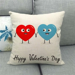 Close-up of linen cushion cover with cartoon heart print and Valentine's Day text