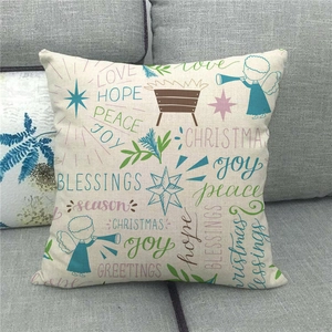 Detail of Christmas linen pillowcase with hand-drawn angel and stars on a grey sofa