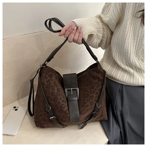 Close-up of brown leopard print hobo bag with vintage metal buckle and leather strap
