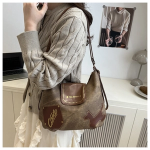Close-up of retro khaki canvas bag with leather patches and Tidal Dryness printed text