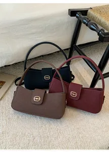 Three retro suede handbags in black, burgundy and dark brown with golden horsebit buckle