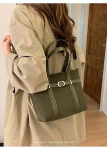 Detail of green woven suede tote bag with retro silver buckle and leather straps