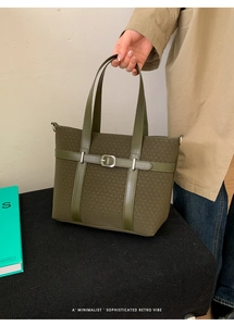 Detailed view of olive green tote bag featuring woven texture and silver metal hardware