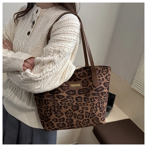 Detail of vintage leopard print tote bag with brown straps and FASHION logo tag
