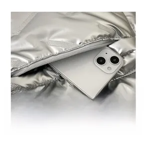 Detail of silver puffer backpack front zipper pocket with smartphone storage