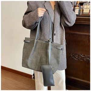 Detail of dark grey tote bag set with matte texture and minimalist side strap design