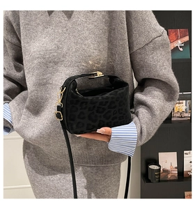 Close-up of leopard print handbag with premium gold hardware and smooth black strap