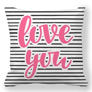 Detail of soft peach skin cushion cover with pink Love you text and black stripes
