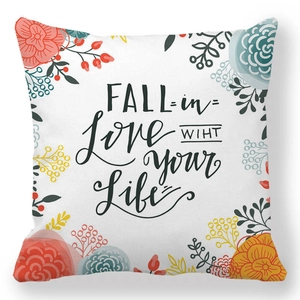 Detail of peach skin pillowcase with floral prints and Fall in Love With Your Life text